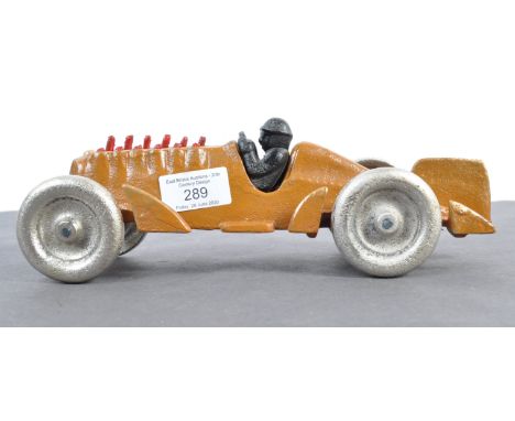 A vintage style contemporary and decorative desk top 20th century cast iron racing car with moving pistons to the engine and 