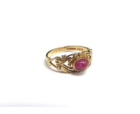 A 9ct gold ring with cabochon ruby with pierced foliate shoulders. Size L/M, 1.9g 