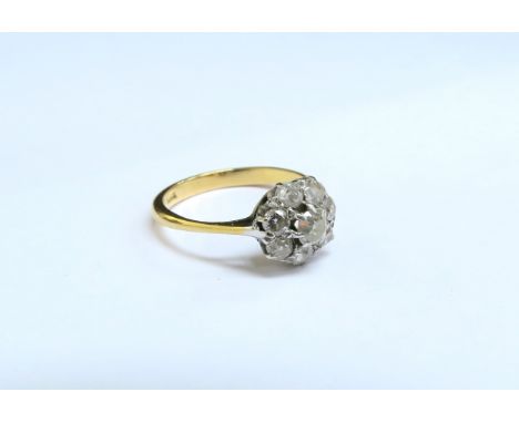 A diamond cluster ring, stamped 18ct. Size N/O, 2.9g 