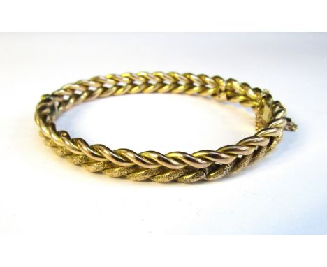 A 9ct gold stiff hinge bangle, frozen chain effect with engraved decoration, 6cm x 5cm, 12.3g 