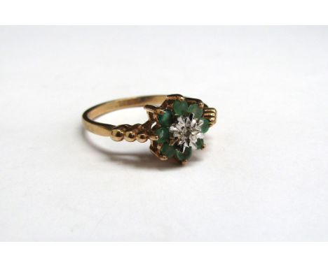 A 9ct gold emerald and diamond daisy ring. Size P, 3.5g 