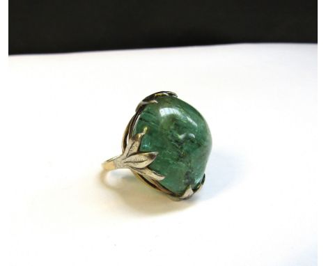 A large irregular shaped cabochon emerald ring, 26mm x 23mm, stamped 14ct, makers H&amp;Co. Size K/L, 17.9g 