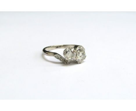 A diamond ring the two diamonds 1ct total approx with diamond set crossover shoulders, stamped 18ct. Size M, 3.6g 
