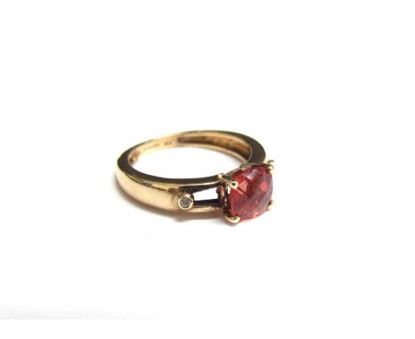 A 9ct gold ring with central sherry topaz in open shoulders set with a single diamond. Size J, 2.3g 