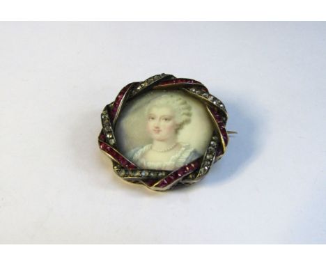 A 19th Century ruby and diamond framed miniature on ivory circular brooch depicting a female in blue and white dress wearing 