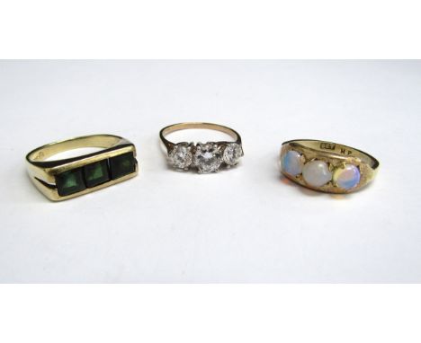 Two 9ct gold rings including three stone example and a 14ct gold ring set with three green stones, 8.9g total 