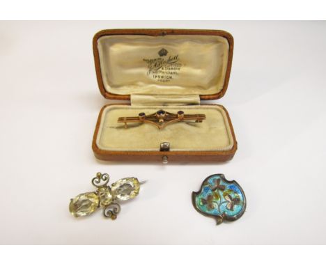 A gold bar brooch stamped 9ct, 2.5g, a silver enamelled brooch and a costume brooch with pale yellow stones (3) 