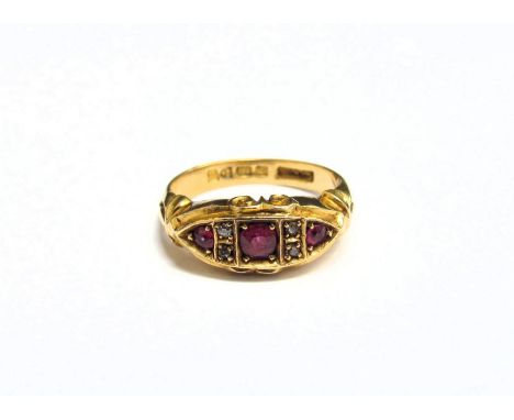 An 18ct gold ring with three rubies spaced by two diamonds. Size M, 5.8g 