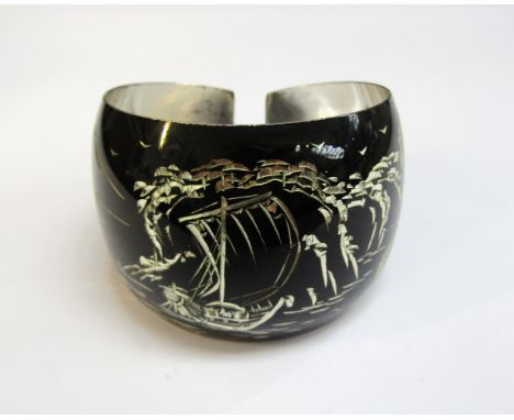 A Japanese silver bangle, the black ground with etched image of mount Fuji and a junk boat, 28.2g 