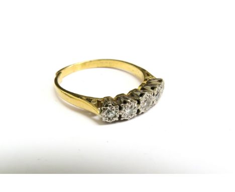 An 18ct gold ring set with five diamonds in illusion setting, cut. Size W, 4.3g 