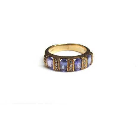 A 9ct gold diamond and tanzanite ring, the four oval tanzanite spaced by three diamonds. Size J, 3.5g 