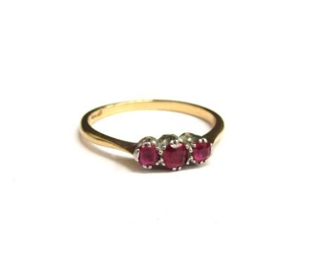 An 18ct gold platinum set ring with three small rubies. Size P, 2.1g 