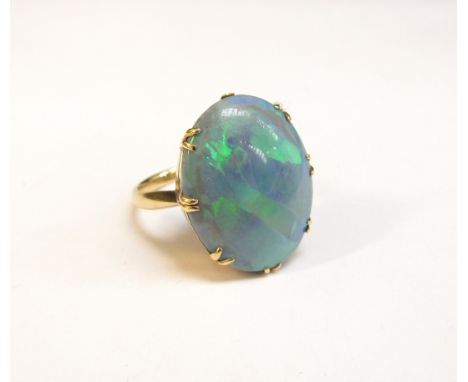 An 18ct gold ring set with a large oval opal, 21mm x 16mm. Size R, 6.5g 