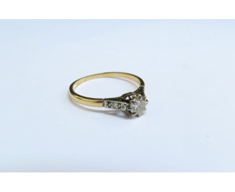 An 18ct gold platinum set diamond solitaire ring 0.50ct approx with diamond set shoulders. Size Q, 2.3g 