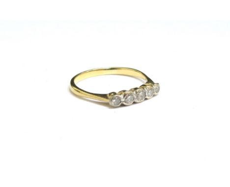 A gold ring with five graduated diamonds in rubover setting, stamped 18ct. Size R, 2.2g 