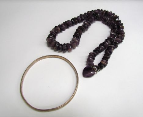 A silver bangle and an amethyst bead necklace with heart shaped charm 