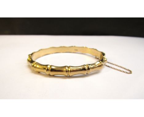 A 9ct gold stiff hinge bangle "bamboo" design, 6.3cm x 5.3cm, 11.9g 