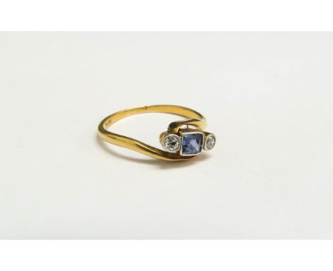 An 18ct gold platinum set sapphire and diamond crossover ring. Size N, 2.1g 