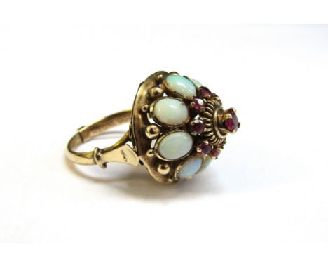 A gold domed cluster ring the centre ruby framed by rubies and opals, unmarked with a 9ct gold spacer. Size M, 6.2g 