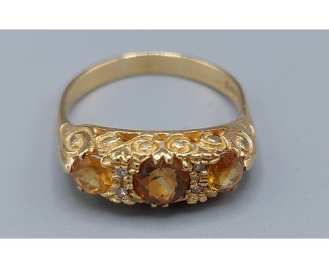 An 18ct gold ring set with three Citrine interspaced with four diamonds 5.1gms, ring size P 