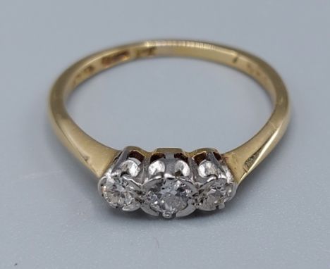 An 18ct gold three stone diamond ring, 2.3gms, ring size L 