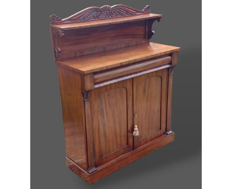 A William IV mahogany chiffonier, the low shelf back above a concealed frieze drawer and two cupboard doors raised upon a pli