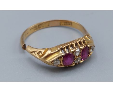 An 18ct gold ring set with two rubies and four diamonds, (band cut) 