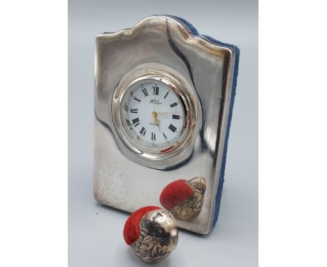 A 925 silver table clock together with a London silver pin cushion in the form of a bird 