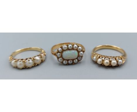 A Victorian opal and pearl set ring together with two rings each set with five pearls 