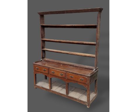 A George III oak dresser, the open shelf back above three drawers with brass handles raised upon square legs with undertier, 