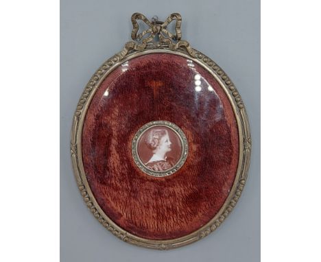 A 19th Century circular portrait miniature, portrait of a lady with diamond chip border, all within an oval frame 