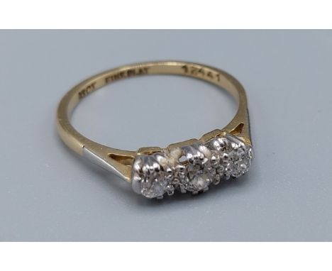 An 18ct gold three stone diamond ring, claw set, 2.2gms, ring size L 