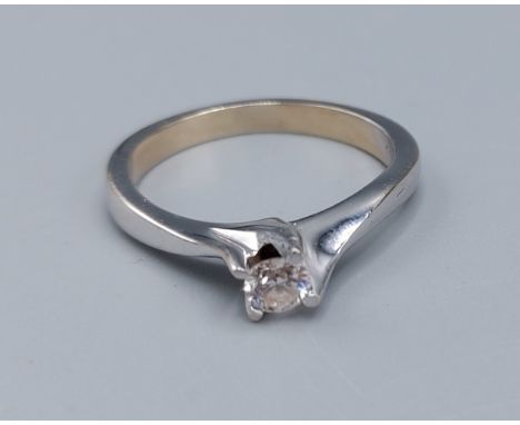 An 18ct white gold solitaire diamond ring, set with a single diamond within a crossover setting, ring size P, 4.3gms 