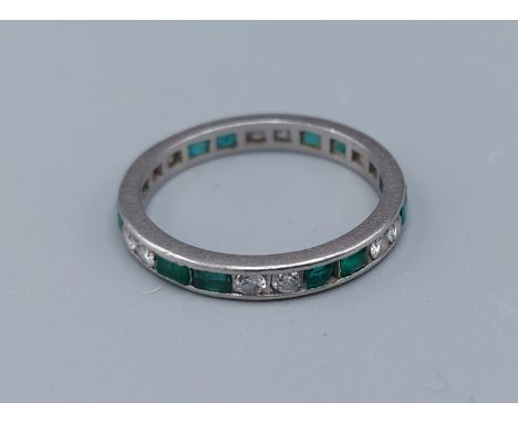 A white gold Emerald and diamond set full eternity ring, 2.8gms, ring size M 