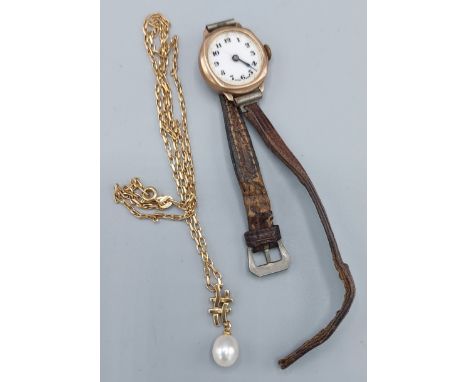 A 9ct gold pearl set pendant together with a 9ct gold linked chain, 5gms together with a 9ct gold cased ladies wristwatch 