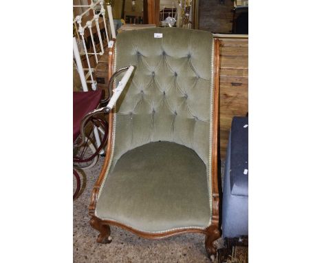 A mahogany framed button backed chair on casters