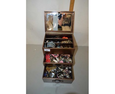 Small bronze effect table top cabinet containing assorted costume jewellery