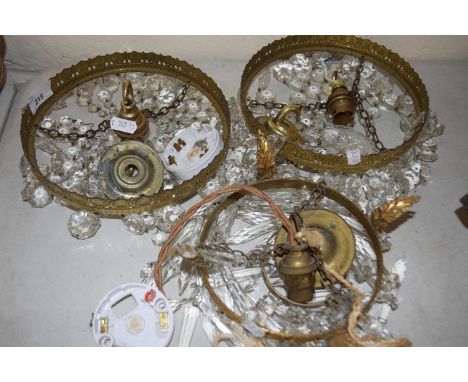Three small hanging ceiling light fittings with glass drapes