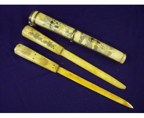 Japanese twin bone knives in brass bound bone engraved scabbard, the knives with 7.25 inch bone blades