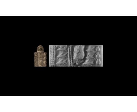Circa 3000 BC. A carved siltstone cylinder seal with pierced handle to end, depicting six fish, accompanied by a museum quali