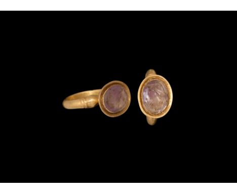 4th century AD. A gold ring comprising a substantial D-section hoop with ribbed collar and bulb to each shoulder, cup bezel w