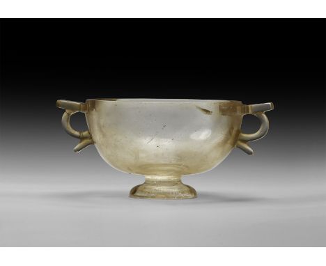 5th-4th century BC. A carved rock crystal skyphos with domed foot, two lateral loop handles with ledge above and spur below. 