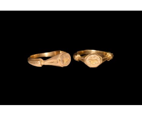3rd century AD. A gold ring comprising a ribbed D-section hoop, steep stepped shoulders, octagonal plaque with crescent detai