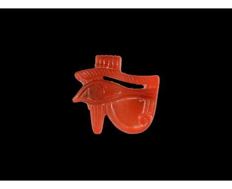 Third Intermediate Period, 1069-702 BC. A carved carnelian amuletic pendant of the wedjat, Eye of Horus, with ribbed suspensi