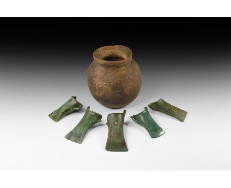 Early 1st millennium BC. A mixed group comprising: five bronze axeheads, each with straight blade, waisted profile, vertical 