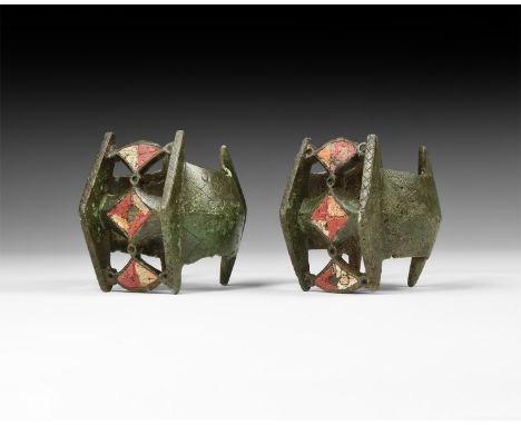 1st-2nd century AD. A matched pair of bronze penannular bracelets, each a keeled band with triangular flange finials, incised