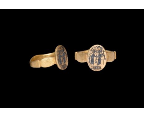 6th-7th century AD. A gold ring comprising a flat-section gold hoop with scaphoid plaque to the underside, barrel-shaped shou