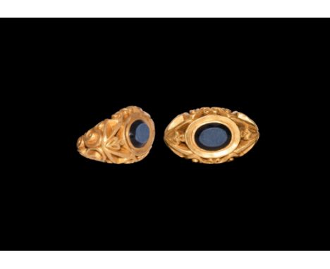 4th century AD. A substantial gold ring comprising a D-section hoop with deeply modelled scroll detailing and voids between, 