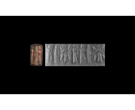 7th-6th century BC. A bronze cylinder seal with winged figure holding the hands of two flanking figures with a third to the s