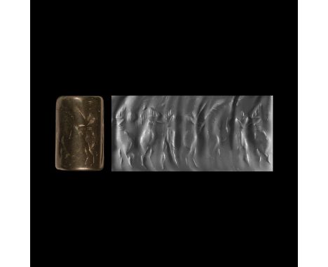 24th-22nd century BC. A large black jasper cylinder seal depicting from left to right: an antithetical group consisting of tw